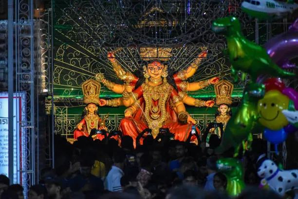 devotees arrive to see an idol of goddess durga at a pandal during the durga puja celebration